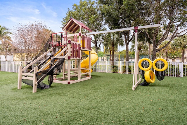 community play area with a yard and fence