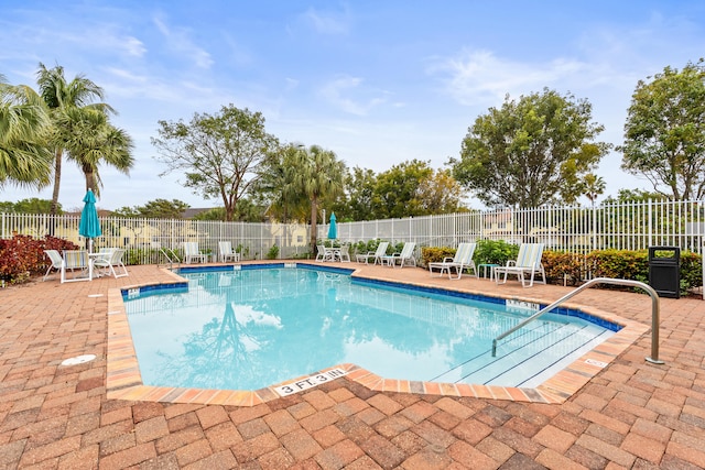 pool featuring a patio area and fence