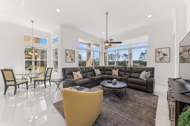 living room with ornamental molding, recessed lighting, plenty of natural light, and a high ceiling