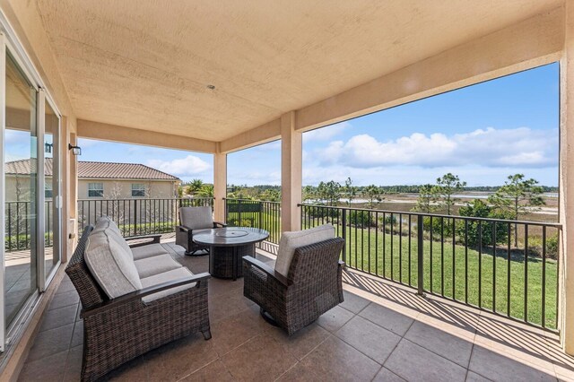 balcony featuring a sunroom and outdoor lounge area