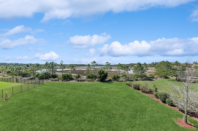 view of yard featuring a rural view and fence