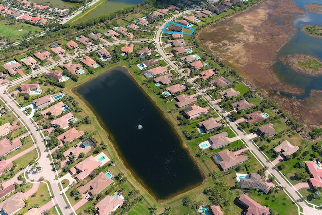 drone / aerial view with a water view and a residential view