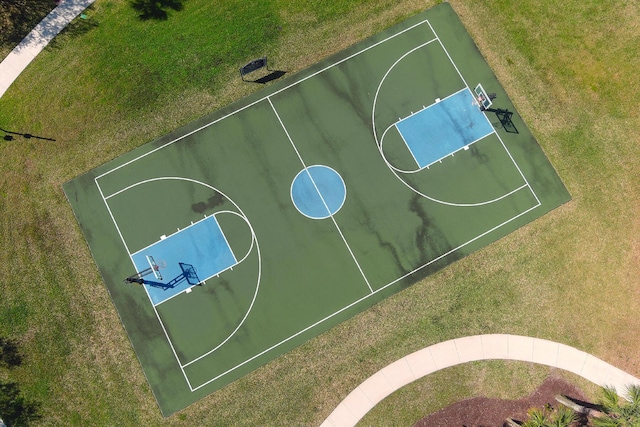 view of basketball court with community basketball court and a yard