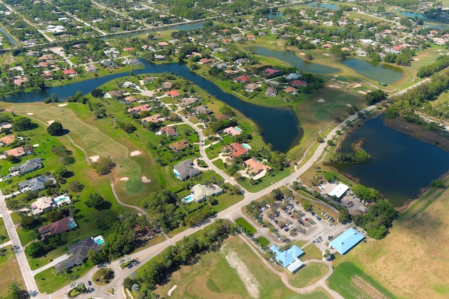 bird's eye view with golf course view, a water view, and a residential view