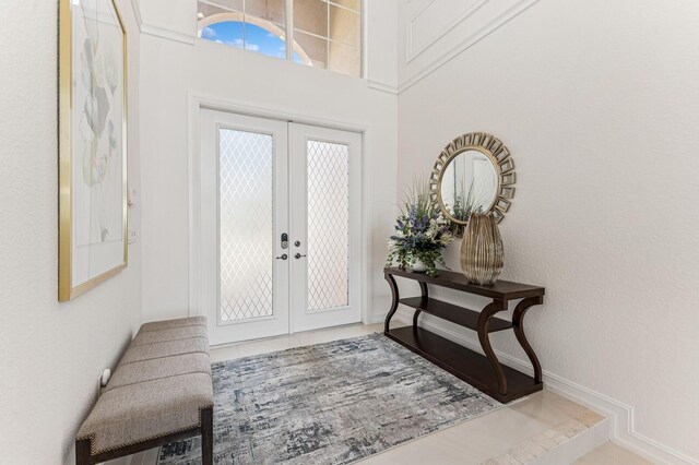 living area with stairs, a high ceiling, ornamental molding, and tile patterned floors