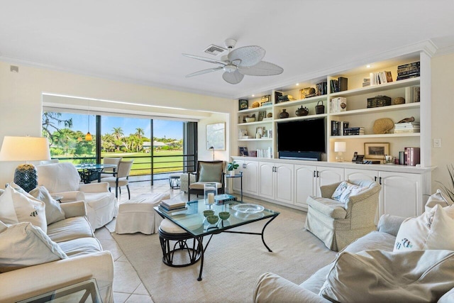 living room with light tile patterned floors, ceiling fan, built in shelves, and ornamental molding