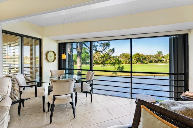 sunroom with a water view and plenty of natural light