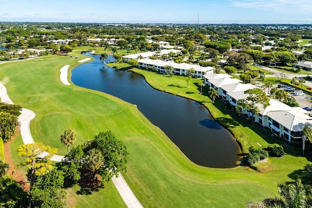 drone / aerial view with a water view and view of golf course