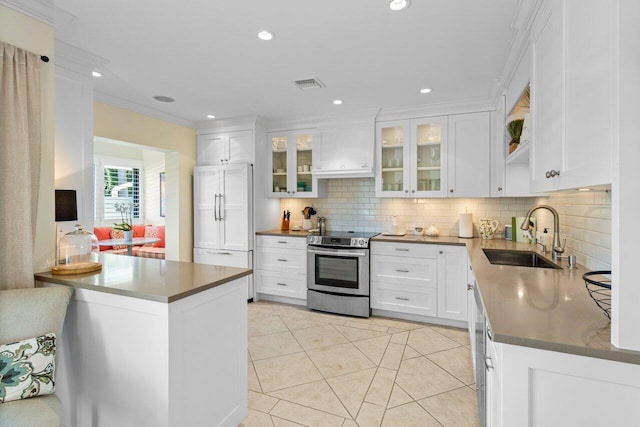 kitchen with stainless steel electric stove, visible vents, white cabinetry, a sink, and paneled built in refrigerator