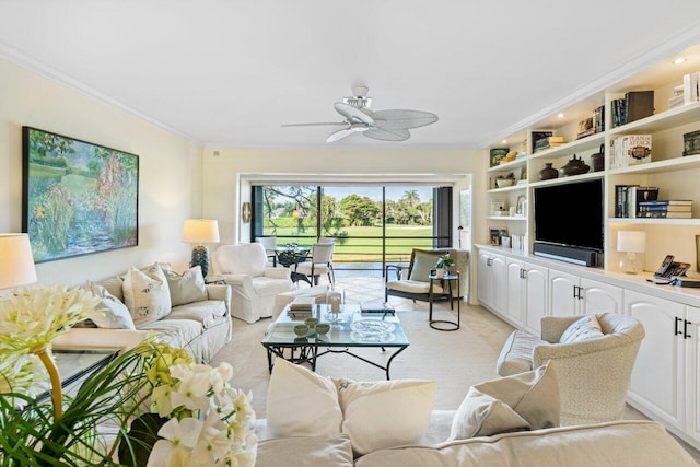 living area featuring built in features, ornamental molding, and a ceiling fan