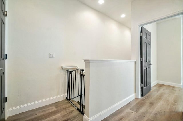 corridor with recessed lighting, baseboards, and wood finished floors