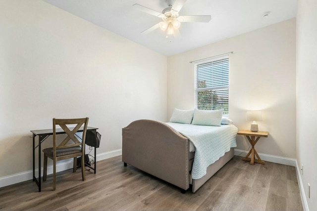 bedroom with wood finished floors, baseboards, and ceiling fan