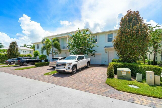 view of front facade featuring decorative driveway and a garage