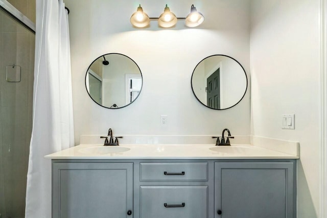 bathroom featuring a sink, a shower with curtain, and double vanity