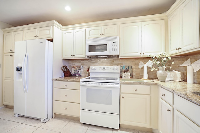 kitchen with light stone counters, white appliances, backsplash, and light tile patterned floors