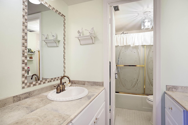 bathroom featuring visible vents, toilet, enclosed tub / shower combo, vanity, and tile patterned floors