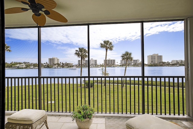 unfurnished sunroom featuring a view of city and a water view