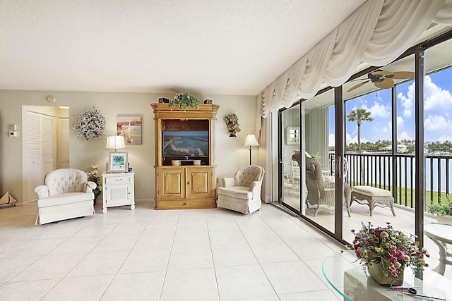 interior space with a wealth of natural light, a textured ceiling, and light tile patterned floors