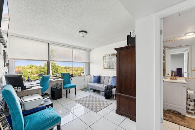 living area featuring a textured ceiling and light tile patterned floors