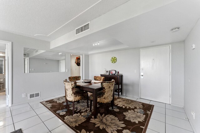 dining area featuring expansive windows, visible vents, ceiling fan, and light tile patterned floors