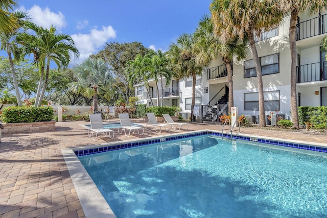 community pool with a patio area