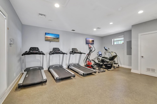 exercise room featuring electric panel, recessed lighting, visible vents, and baseboards