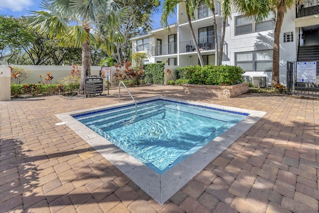 view of swimming pool with a patio area and fence