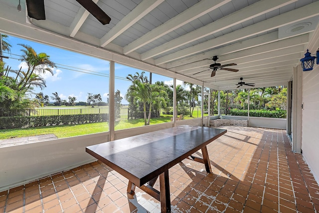 unfurnished sunroom featuring beamed ceiling