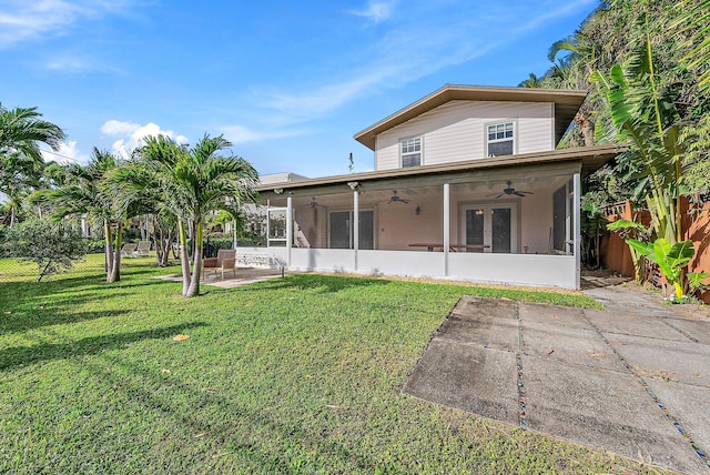 back of house featuring a sunroom, a patio area, a yard, and ceiling fan