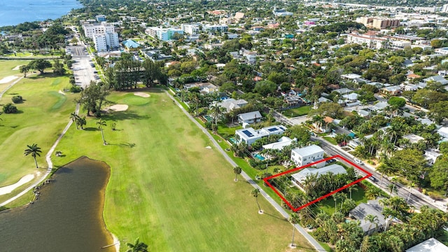 bird's eye view featuring a water view and view of golf course