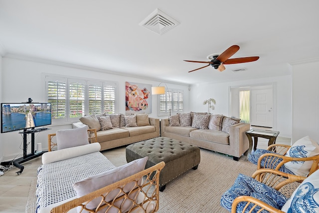 living room with ornamental molding, a healthy amount of sunlight, and visible vents