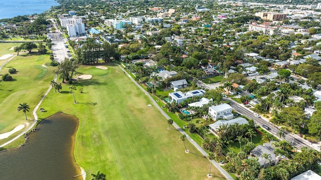 birds eye view of property with a water view and view of golf course