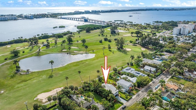 drone / aerial view featuring golf course view and a water view