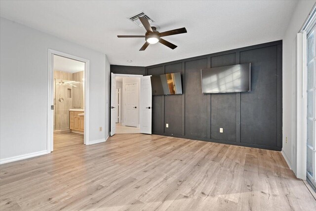 unfurnished bedroom with baseboards, visible vents, a ceiling fan, ensuite bathroom, and light wood-style floors