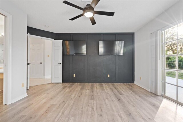 unfurnished bedroom with baseboards, a ceiling fan, and light wood-style floors