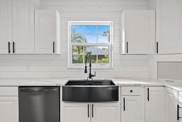 kitchen featuring a sink, light stone countertops, white cabinets, and dishwasher