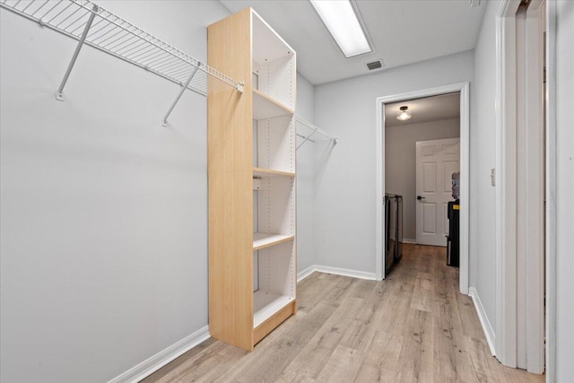 spacious closet with light wood-style flooring and visible vents