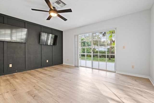 unfurnished room with light wood-type flooring, baseboards, visible vents, and a ceiling fan