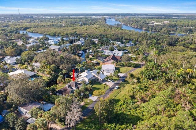 birds eye view of property featuring a residential view, a water view, and a forest view