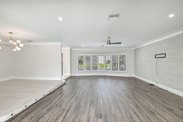 unfurnished living room with ornamental molding, visible vents, baseboards, and wood finished floors