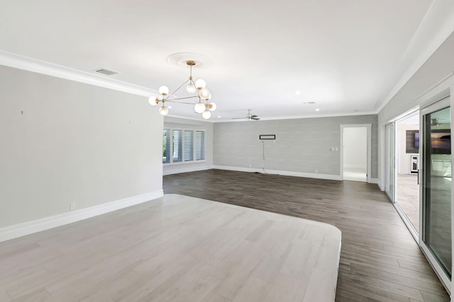 unfurnished living room with crown molding, dark wood finished floors, and baseboards