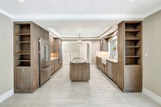 kitchen featuring a center island, open shelves, stainless steel appliances, light stone countertops, and baseboards