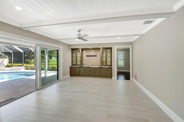 interior space featuring visible vents, beamed ceiling, a sunroom, and baseboards