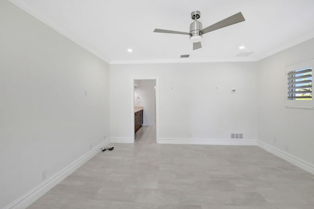 empty room with baseboards, visible vents, and ornamental molding