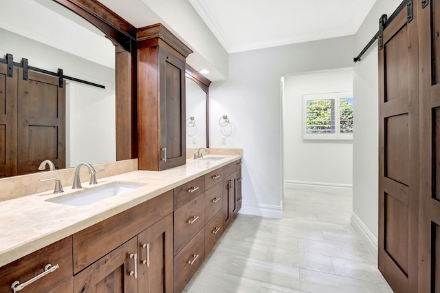 bathroom featuring double vanity, baseboards, a sink, and ornamental molding