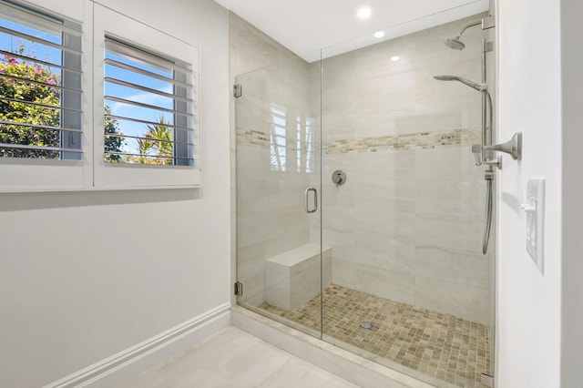 full bath with a stall shower, baseboards, and recessed lighting