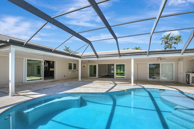 rear view of property featuring a patio area, ceiling fan, and stucco siding