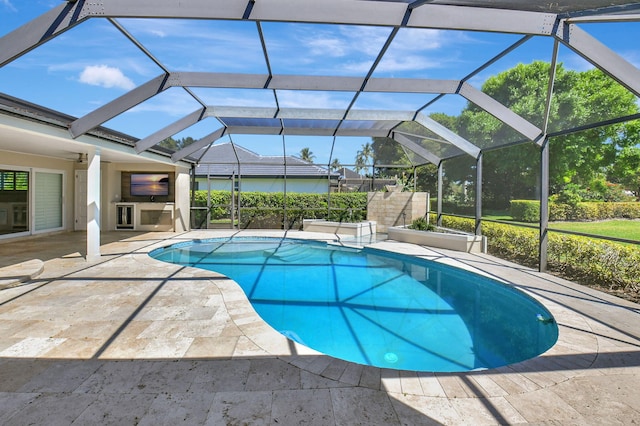 outdoor pool with a lanai and a patio area