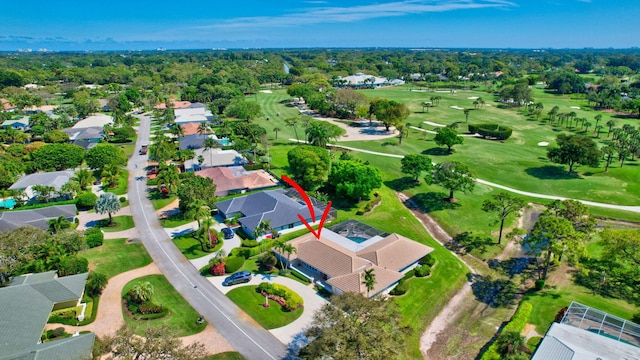 drone / aerial view with a residential view and golf course view