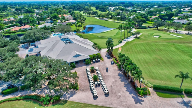 birds eye view of property with view of golf course and a water view